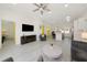 Spacious open floor plan with modern furnishings, wood-look floors, and a view of the bright kitchen at 3090 6Th St, Sarasota, FL 34237