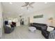Open concept living area with wood-look floors, stylish seating, and a kitchen island at 3090 6Th St, Sarasota, FL 34237
