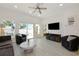 Bright and airy living room featuring sliding glass doors leading to an outdoor patio area at 3090 6Th St, Sarasota, FL 34237