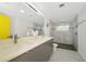 Bathroom featuring double sinks, ample countertop space, and walk-in shower with pebble floor at 3090 6Th St, Sarasota, FL 34237