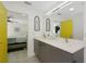Bathroom featuring double sinks, quartz countertops, and yellow door at 3090 6Th St, Sarasota, FL 34237