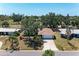 An aerial view of a single-story home with tile roof surrounded by lush greenery and neighboring houses at 3336 Pembrook Dr, Sarasota, FL 34239