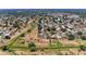 Wide aerial shot of a community, showing residential streets, a golf course and tropical landscaping at 3336 Pembrook Dr, Sarasota, FL 34239