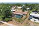 Aerial view of a home with a screened pool and lush landscaping at 3336 Pembrook Dr, Sarasota, FL 34239