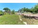 Spacious backyard with stone pathway and white arbor at 3336 Pembrook Dr, Sarasota, FL 34239