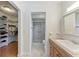 Bright bathroom with shower, sink, and direct access to a walk-in closet at 3336 Pembrook Dr, Sarasota, FL 34239