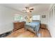 Cozy bedroom with a bed, dresser, and a view of the outdoors at 3336 Pembrook Dr, Sarasota, FL 34239