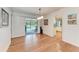 Bright dining room with hardwood floors, access to the pool, and modern lighting at 3336 Pembrook Dr, Sarasota, FL 34239