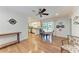 Open-concept dining area with hardwood floors, fan, and view of the pool creates a seamless flow for entertaining at 3336 Pembrook Dr, Sarasota, FL 34239