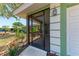 Inviting screened-in front entrance with brick flooring and lush landscaping adds curb appeal to this home at 3336 Pembrook Dr, Sarasota, FL 34239