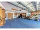 Spacious garage featuring ample storage, shelving, and a clean workspace with a convenient work bench at 3336 Pembrook Dr, Sarasota, FL 34239