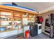 Organized garage features laundry area, sink, storage shelves, and space for equipment at 3336 Pembrook Dr, Sarasota, FL 34239