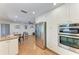 Modern kitchen with stainless steel appliances, white cabinetry, and adjacent dining area for casual meals and gatherings at 3336 Pembrook Dr, Sarasota, FL 34239