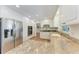 Bright kitchen with white cabinetry, stainless steel appliances, and stone countertops with a view to hallway at 3336 Pembrook Dr, Sarasota, FL 34239
