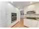 Well-equipped kitchen with stainless steel appliances, white cabinetry, and modern fixtures at 3336 Pembrook Dr, Sarasota, FL 34239