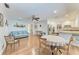 Inviting living room featuring wood floors, fan, comfortable furniture, and open access to the kitchen at 3336 Pembrook Dr, Sarasota, FL 34239