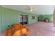Covered patio featuring a brick floor, ceiling fans, and a built-in grill at 3336 Pembrook Dr, Sarasota, FL 34239