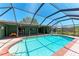 Inviting pool with brick surround, screened enclosure, and ample patio space for entertaining and enjoying the outdoors at 3336 Pembrook Dr, Sarasota, FL 34239