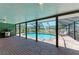 Covered patio by a private swimming pool with brick flooring at 3336 Pembrook Dr, Sarasota, FL 34239