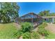 Inviting screened-in pool in a private backyard setting at 3336 Pembrook Dr, Sarasota, FL 34239