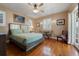Comfortable bedroom with wood floors, neutral colors, a queen bed, and a sitting area with chairs at 344 N Lantana N Ave, Sarasota, FL 34243