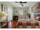 Comfortable bedroom with hardwood floors, a ceiling fan, and natural light at 344 N Lantana N Ave, Sarasota, FL 34243