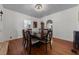 Elegant dining room showcasing hardwood floors and a classic chandelier, perfect for entertaining at 344 N Lantana N Ave, Sarasota, FL 34243