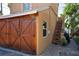 Exterior view of the garage featuring wood doors and a staircase with a custom grill at 344 N Lantana N Ave, Sarasota, FL 34243