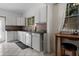 Bright kitchen featuring white cabinets, granite countertops, stainless steel appliances, and tile flooring at 344 N Lantana N Ave, Sarasota, FL 34243