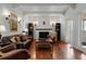 Cozy living room featuring hardwood floors, a fireplace, and ample natural light at 344 N Lantana N Ave, Sarasota, FL 34243