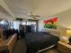 Bedroom with a large bed, dresser, and natural light coming through the large windows at 3805 E Bay Dr # 302, Holmes Beach, FL 34217