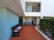 Courtyard with colorful benches, brick floors, decorative art, and plants at 3805 E Bay Dr # 302, Holmes Beach, FL 34217