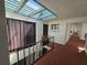 Hallway with brick floors and a skylight with natural light, with plants, and a hallway in the background at 3805 E Bay Dr # 302, Holmes Beach, FL 34217