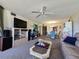 Inviting living room with comfortable seating, a ceiling fan, and a view into the dining area at 3805 E Bay Dr # 302, Holmes Beach, FL 34217