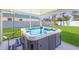 Relaxing backyard with an in-ground hot tub, perfect for enjoying the outdoors at 3889 Canopy Way, Sarasota, FL 34235