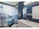 Bathroom highlighting a seaside-themed shower curtain and modern vanity against a blue accent wall at 3889 Canopy Way, Sarasota, FL 34235