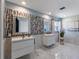Bright bathroom featuring double vanity sinks, modern fixtures, and stylish tile backsplash at 3889 Canopy Way, Sarasota, FL 34235
