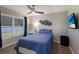 Bedroom features a full bed, ceiling fan and a large window letting in ample natural light at 3889 Canopy Way, Sarasota, FL 34235