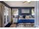 This bedroom features blue walls, a king bed, and access to a private outdoor patio at 3889 Canopy Way, Sarasota, FL 34235