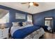 Bright bedroom features blue walls, a king bed, and two bedside tables with lamps at 3889 Canopy Way, Sarasota, FL 34235
