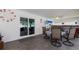Relaxing covered patio with a ceiling fan, a dining table and view of the outdoors at 3889 Canopy Way, Sarasota, FL 34235
