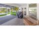 Screened-in patio featuring a BBQ grill and an outdoor seating area, offering a relaxing outdoor experience at 3889 Canopy Way, Sarasota, FL 34235
