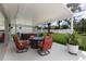 Spacious covered patio with a fire pit, comfortable seating, and a hot tub, ideal for outdoor gatherings at 3889 Canopy Way, Sarasota, FL 34235