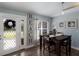 Cozy dining area with natural light, a stylish table setting, and beach-themed decor, ideal for Gathering meals at 3889 Canopy Way, Sarasota, FL 34235