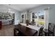 Bright and airy dining room with dark furniture and an open floor plan at 3889 Canopy Way, Sarasota, FL 34235