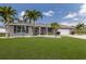 Inviting single-story home with a manicured lawn and elegant landscaping at 3889 Canopy Way, Sarasota, FL 34235