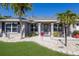 Welcoming front entrance with decorative pillars and lush, tropical landscaping at 3889 Canopy Way, Sarasota, FL 34235