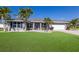 Beautiful single-story home with well-manicured lawn and tropical landscaping at 3889 Canopy Way, Sarasota, FL 34235
