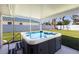 Outdoor hot tub on a covered patio, perfect for relaxation and enjoying the backyard view at 3889 Canopy Way, Sarasota, FL 34235