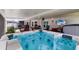 Inviting covered patio featuring a hot tub with exterior seating and a mounted television for relaxation and entertainment at 3889 Canopy Way, Sarasota, FL 34235